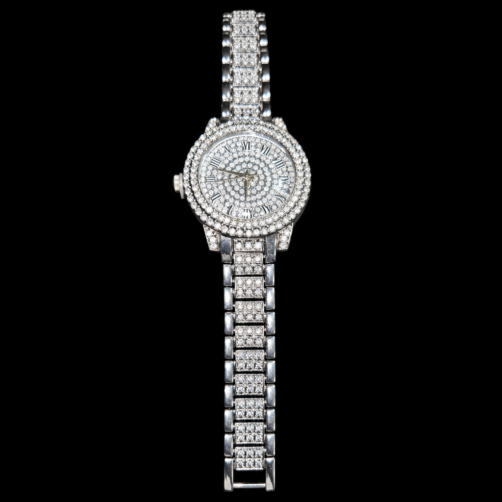 Silver-tone round Roman numeral watch with sparkling clear stone accents and a matching bracelet on a black background.