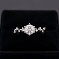 Clear stone ring with flower-like cluster of sparkling accents
