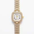 Gold-tone square Roman-numeral watch with clear accent stones and a single bracelet band on white