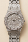 Silver-tone sparkling round dial bracelet watch on a neutral ivory background