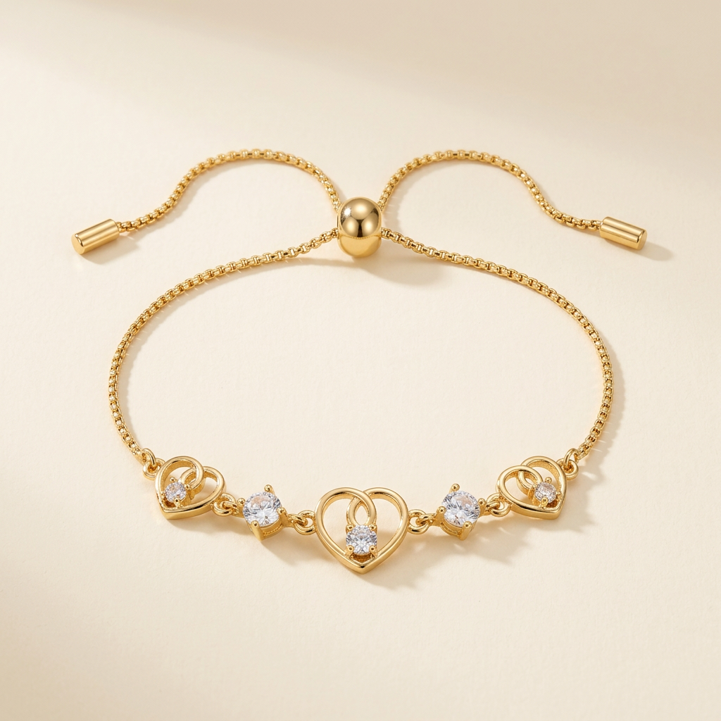 Gold-tone triple heart slider bracelet on a neutral ivory background