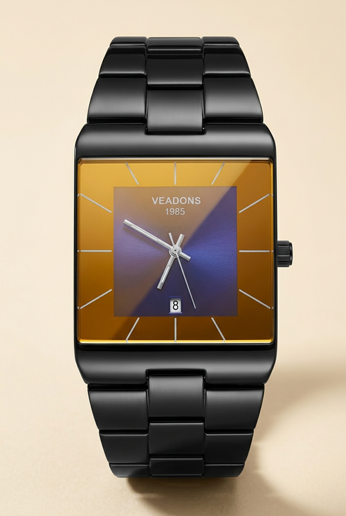 Black-tone rectangular watch with amber dial on a neutral ivory background