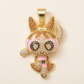 Close-up of gold-tone sparkling character pendant on a neutral background