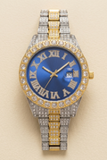 Two-tone sparkling blue dial Roman numeral watch on a neutral ivory background