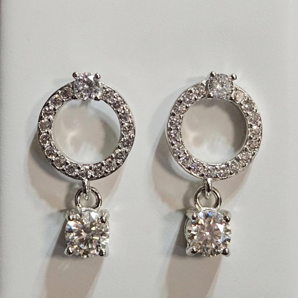 Close-up of silver-tone sparkling open circle drop earrings