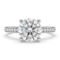 Round clear-stone solitaire ring with a silver-tone accent-stone band on white