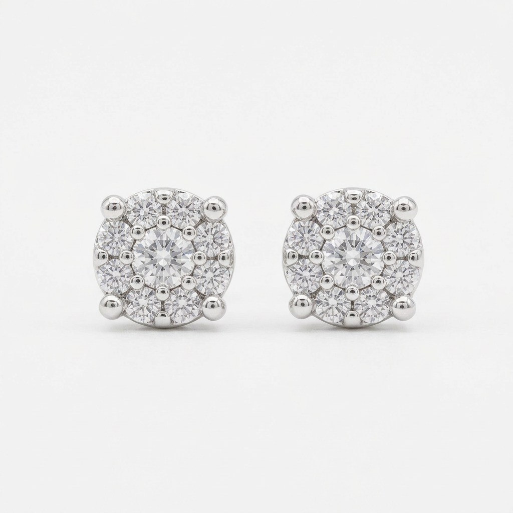 Close-up of two round clear stone stud earrings in silver-tone prong settings on a white background