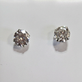 Close-up of round clear-stone studs with silver-tone prong settings
